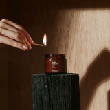 Wonderstate Sexual Wellness Burn Massage Candle by Maude being lit