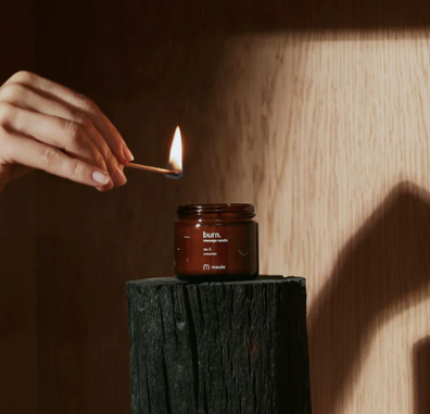 Wonderstate Sexual Wellness Burn Massage Candle by Maude being lit