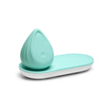 Evii clitoral vibrator by Biird in color mint with charging tray