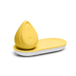 Evii clitoral vibrator by Biird in color Yellow on charging tray