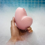Clitoral vibrator and satisfyer suction Namii by Biird in pink in bath