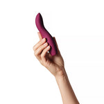 Wonderstate Sexual Wellness Clitoral Vibrator Dip 2.0 by Dame Plum with hand